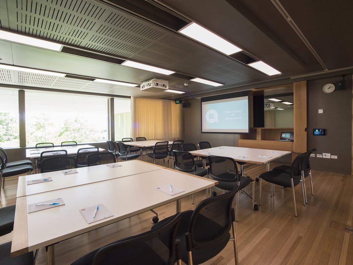 Heritage Collections Learning room set with tables, chairs and a projector