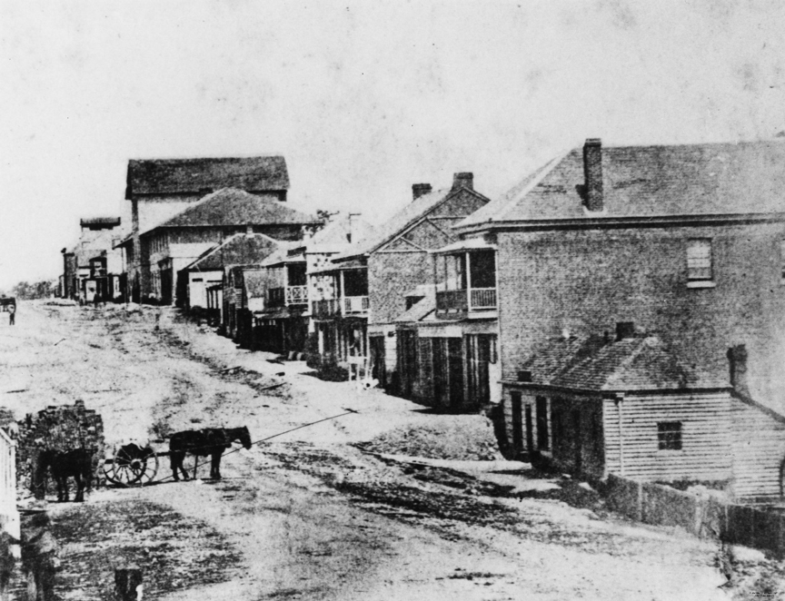 An earl street with a horse and cart in the foreground