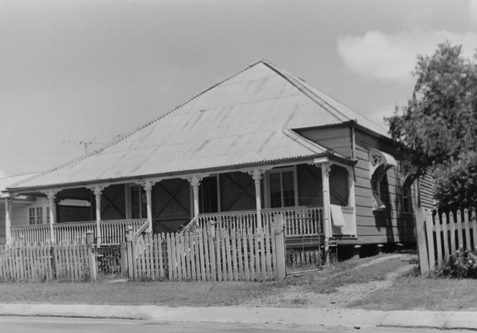 Picture of a house with a pointed roof and a verandah