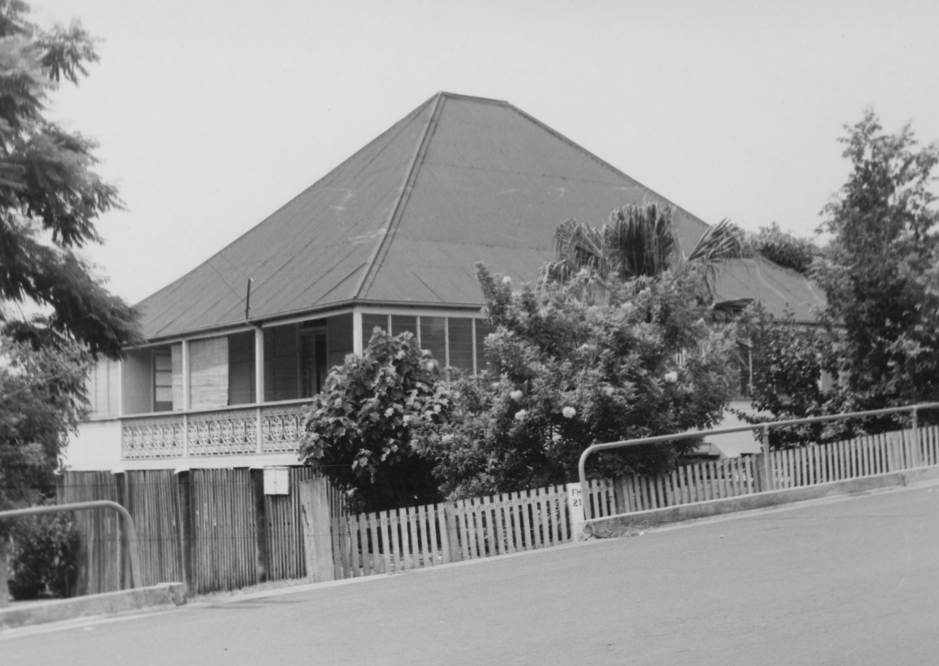 House with pointed roof, picket fence and shrubs in Newton