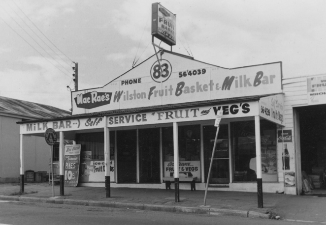 A black and white photograph of a shop front advertised as Fruit Basket and Milk Bar at Wilston