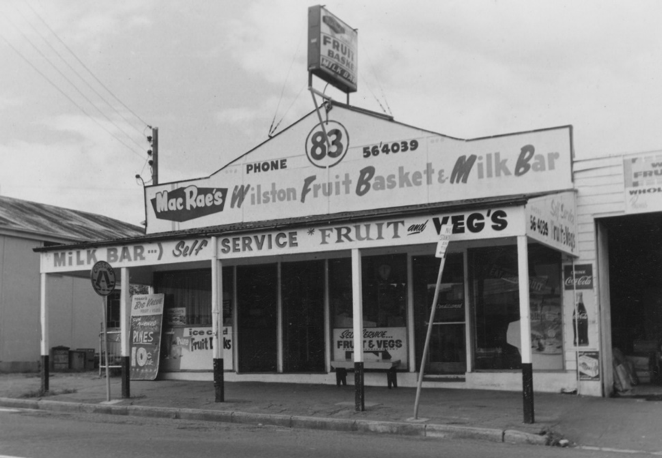 A black and white photograph of a shop front advertised as "Fruit Basket and Milk Bar" at Wilston