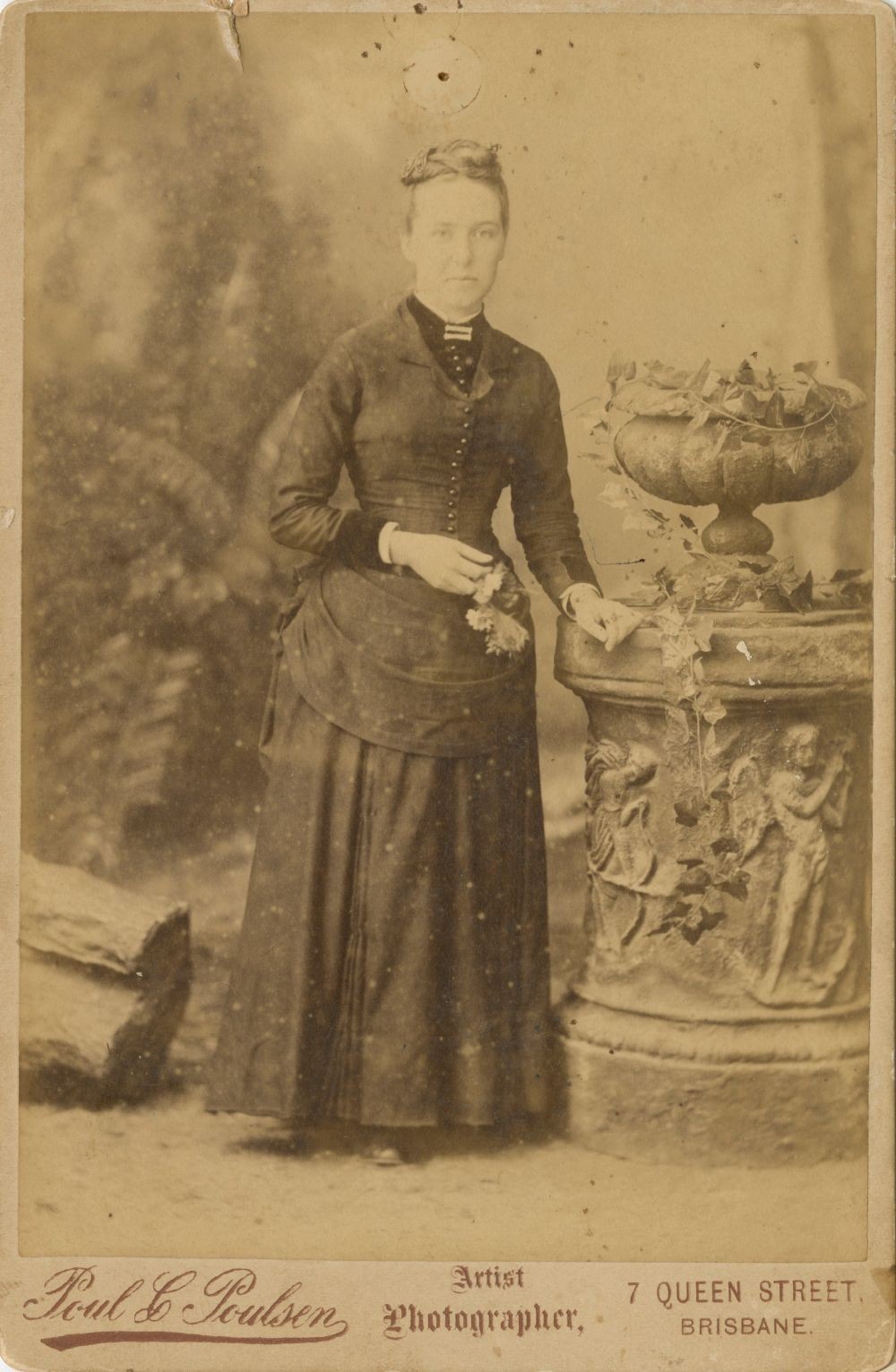 Sepia studio potrait of Polly Board wearing long sleeved ankle length dress