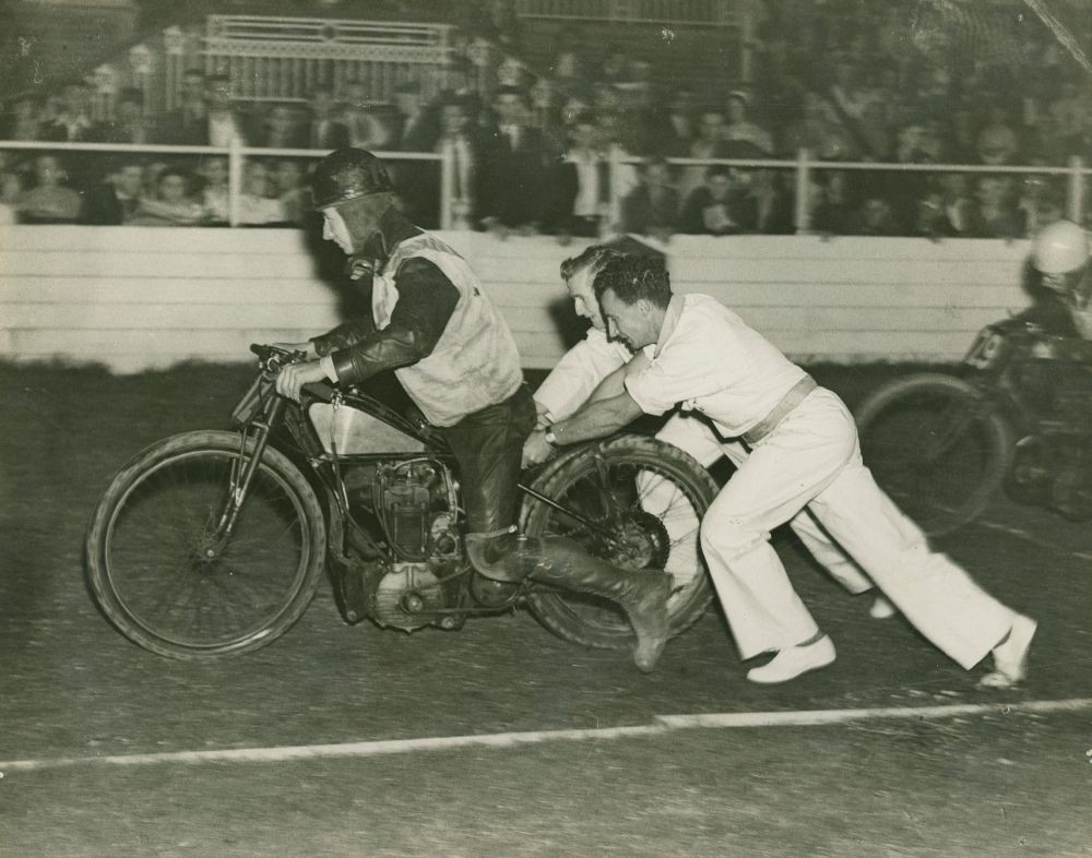 Motor bike racer getting a push start at the track, Brisbane.