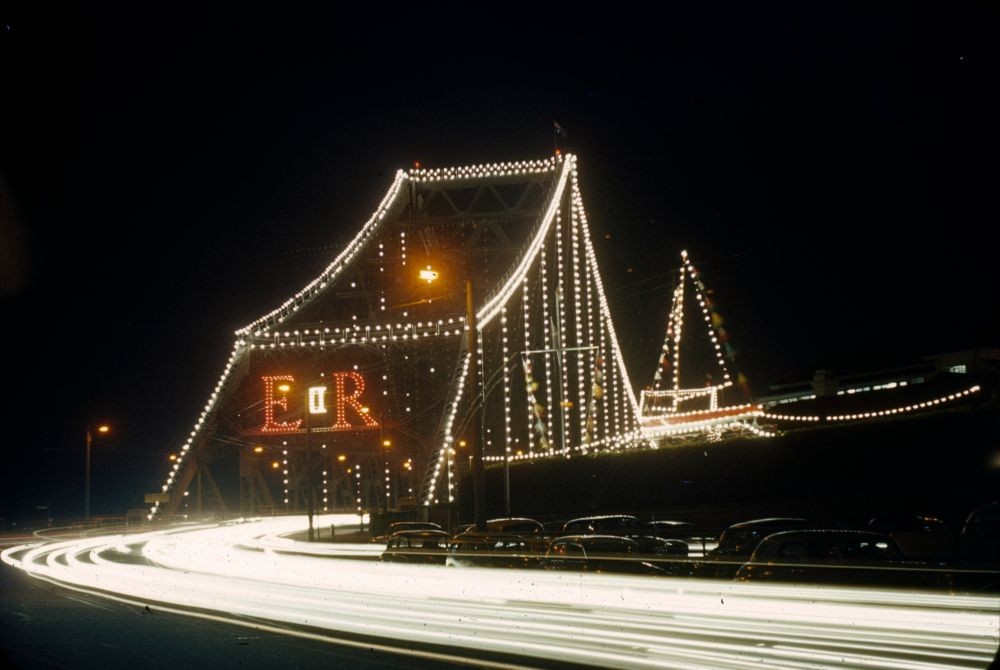 The Story Bridge decorated with lights for the royal tour in 1954, 30541 Brisbane Royal Visits 1954 and 1959 colour slides, John Oxley Library, State Library of Queensland, Image no: 30541-0001-0035