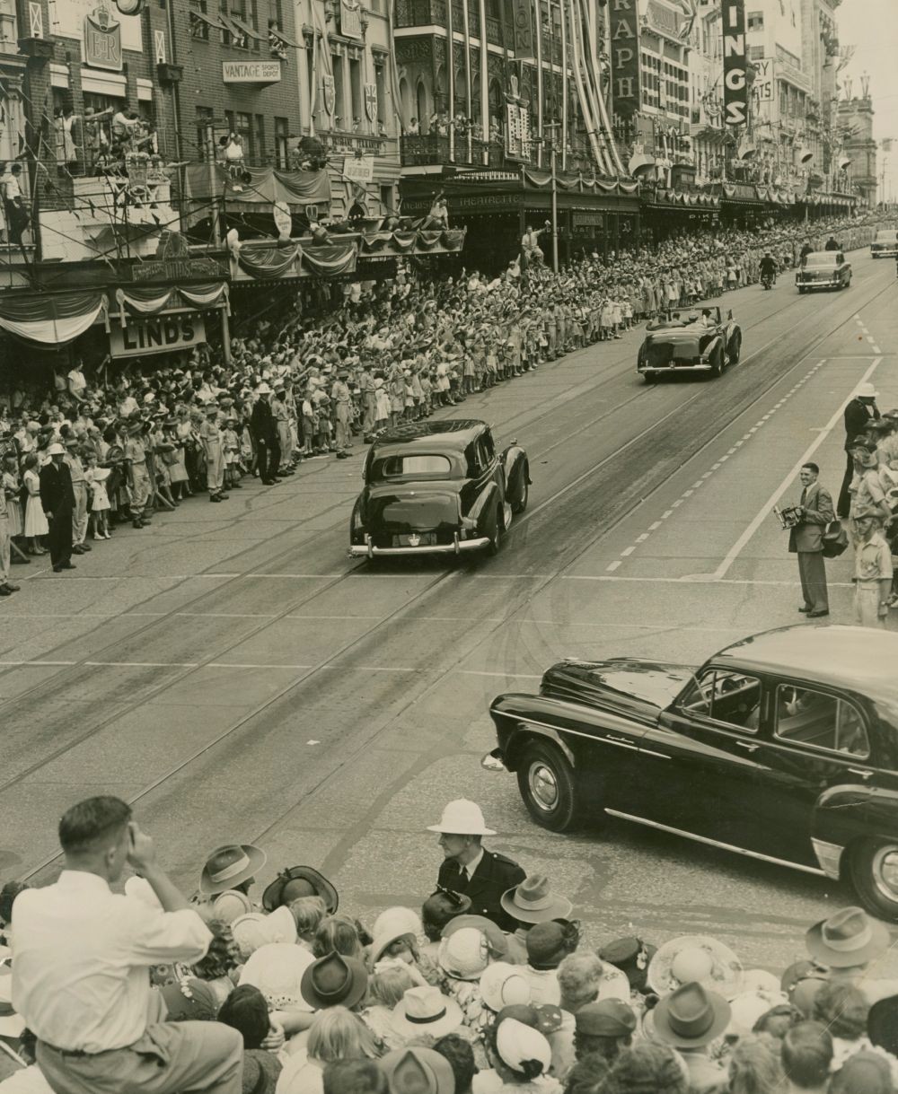 Large crowds line the streets as the royal entourage drives past Queensland 1954