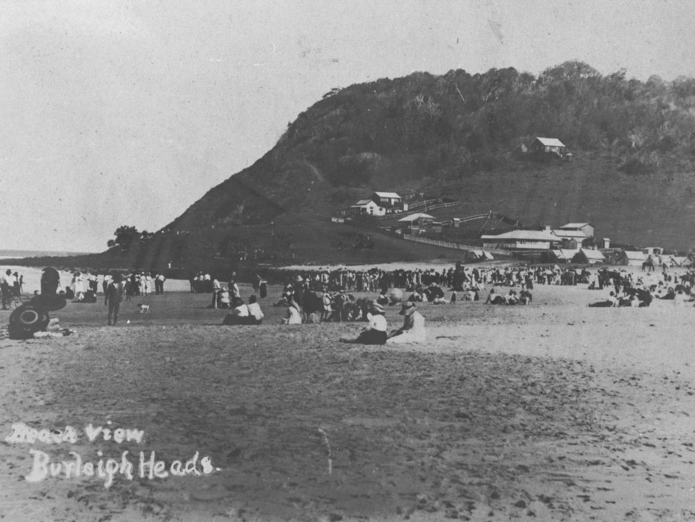 black and white photo of Burleigh headland with people on the beach 