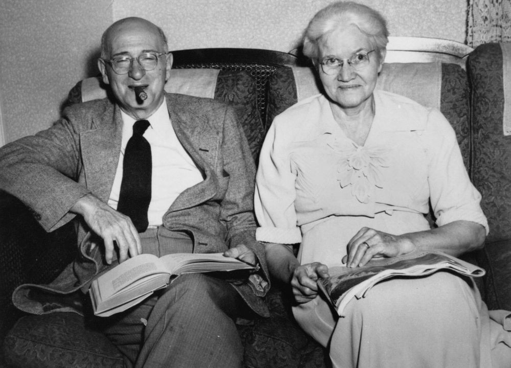 Two people sitting on a lounge reading