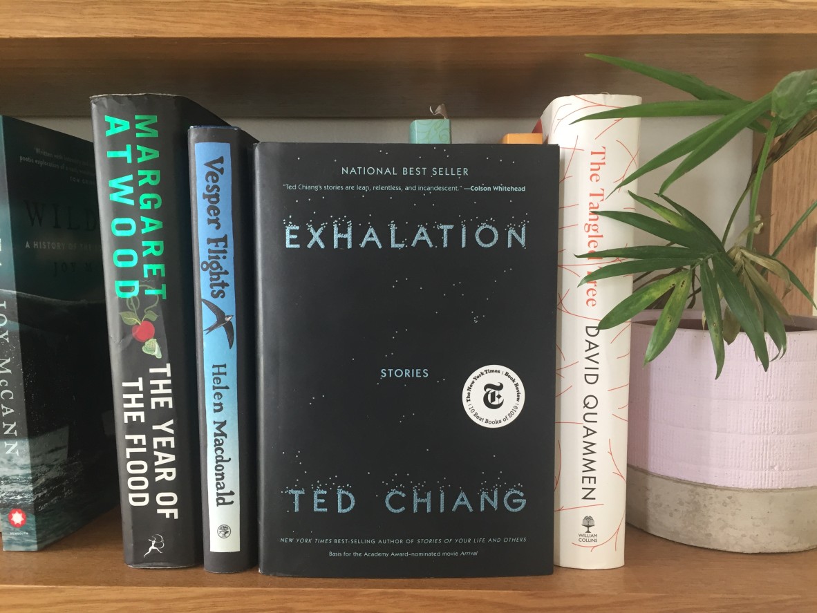 Exhalation by Ted Chiang sits on a bookshelf with books by Margaret Atwood Helen Macdonald and David Quammen