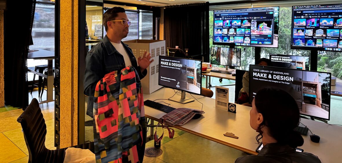 Textile Artist named Ben Tupas explains his idea to the class.