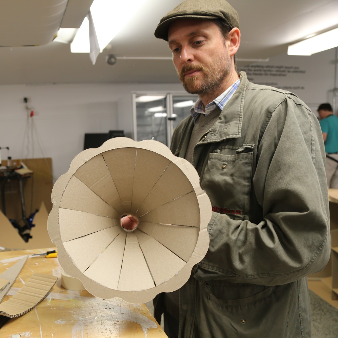 Man holding fluted cardboard gramophone horn