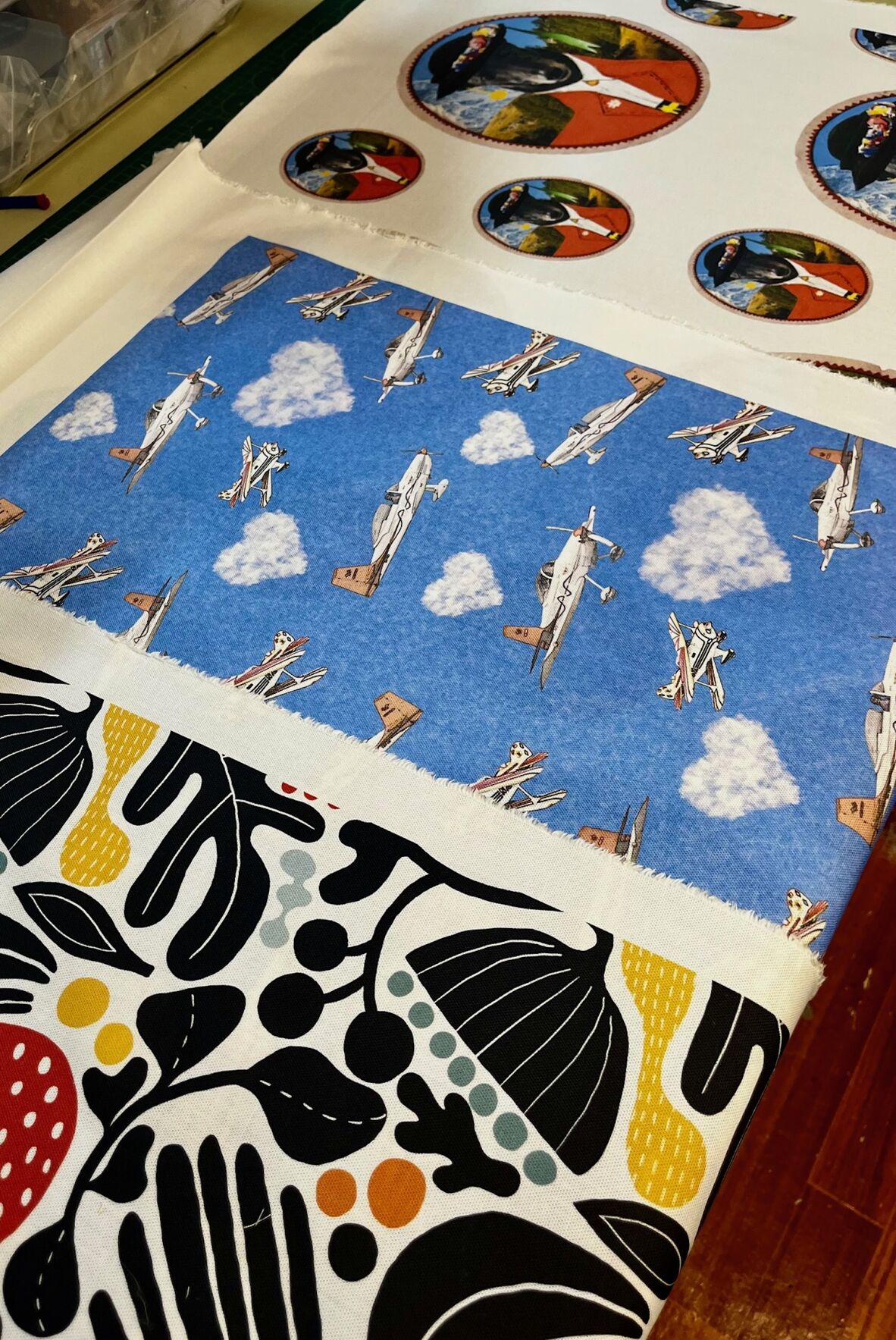 A photo of 3 printed fabrics displayed on a table
