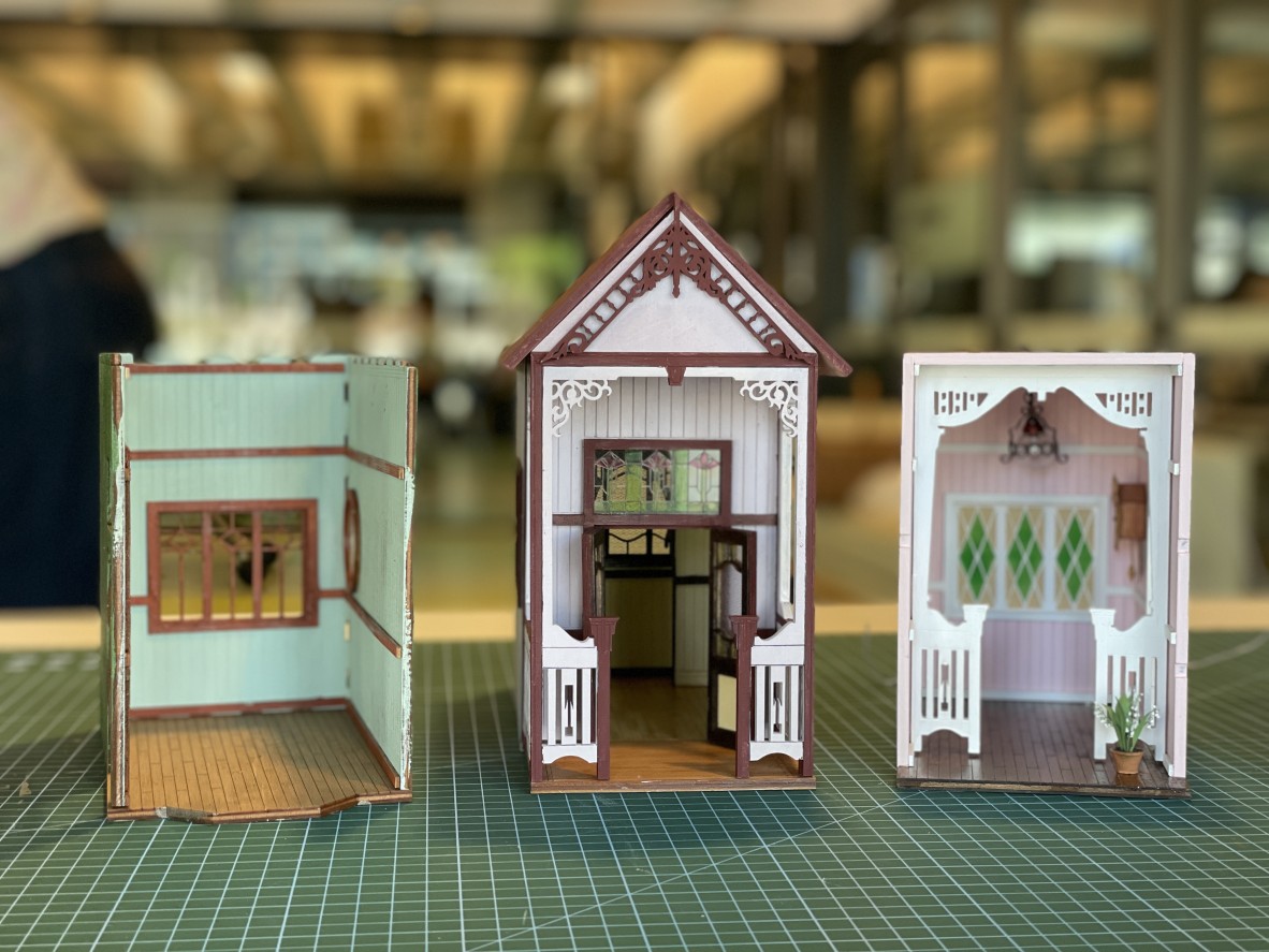 A row of queensland in miniature book nooks.
