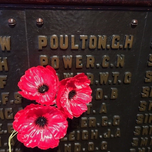 A picture of a plaque with poppies