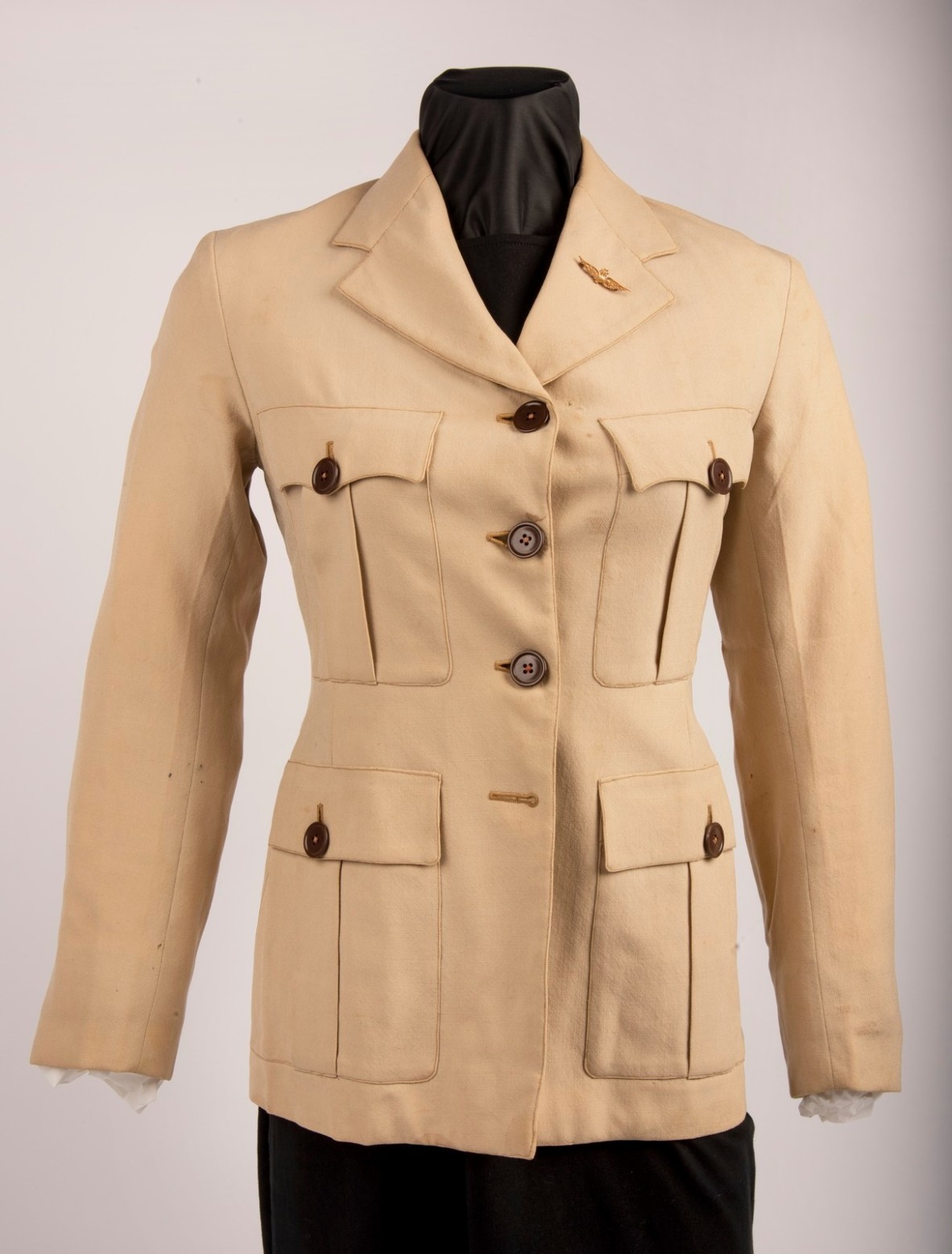 A vintage women khaki flying jacket on a mannequin dummy