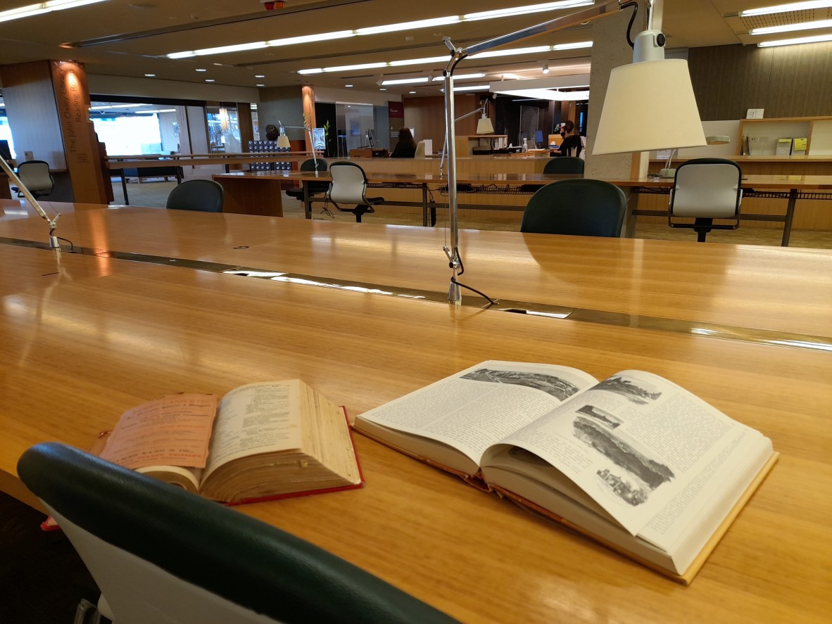 Two books open on a desk in the JOL library
