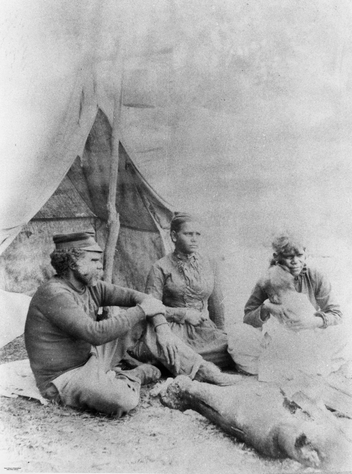 Salvation Jacko and family sitting in front of tent at Deebing Creek Mission, Ipswich District, ca. 1900