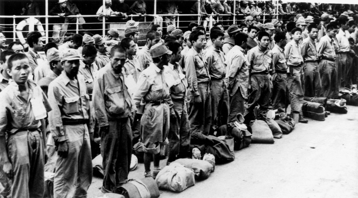 Black and white photograph of Japanese prisoners arriving at Brisbane from New Guinea ca 1945