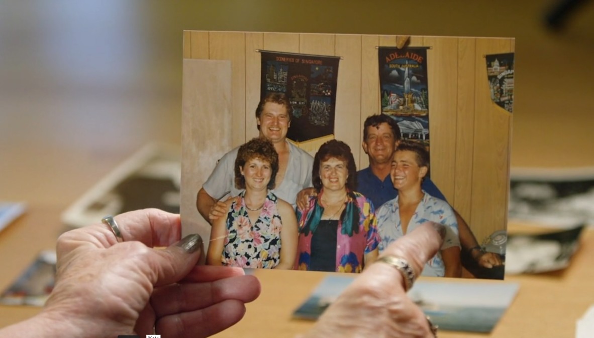 Jean Hoffman holding a family photograph.