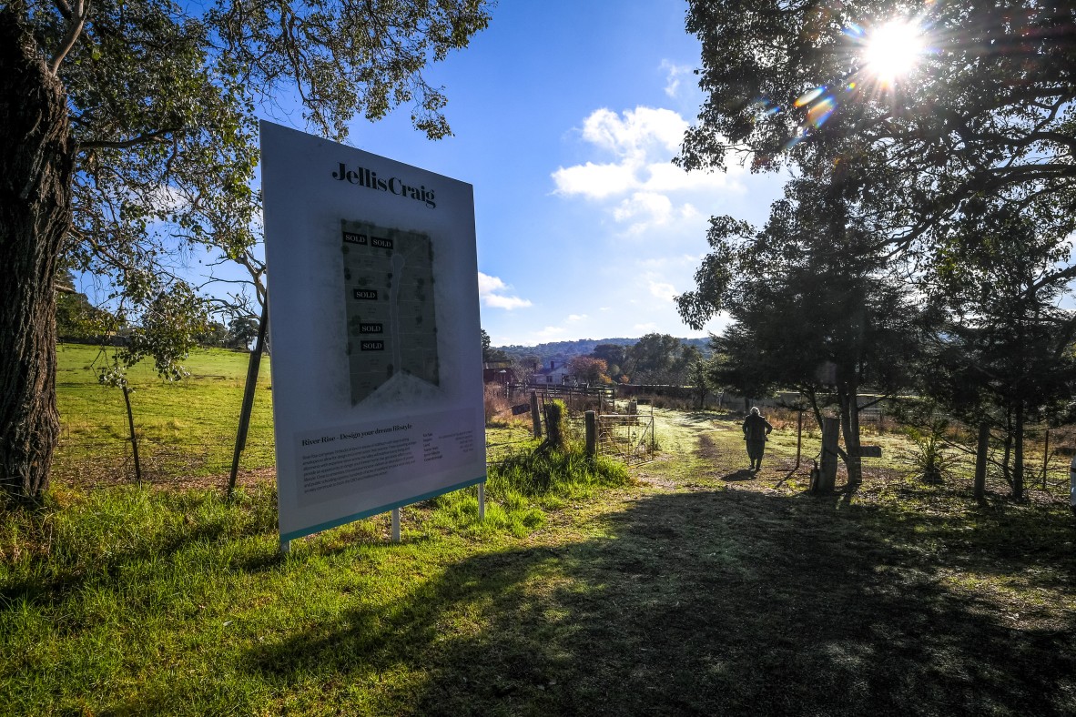  A photo of a sign advertising property for sale at the front gate of the farm.