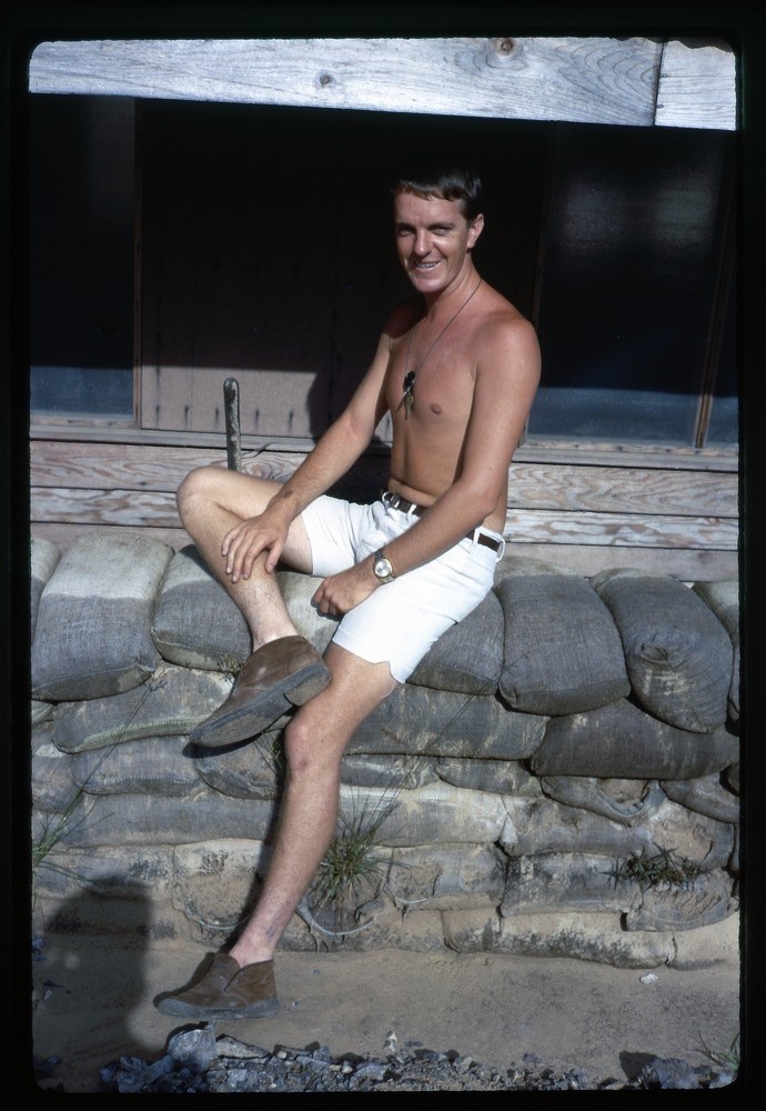 Australian Serviceman sat on sandbags in Vietnam, 1968-69.