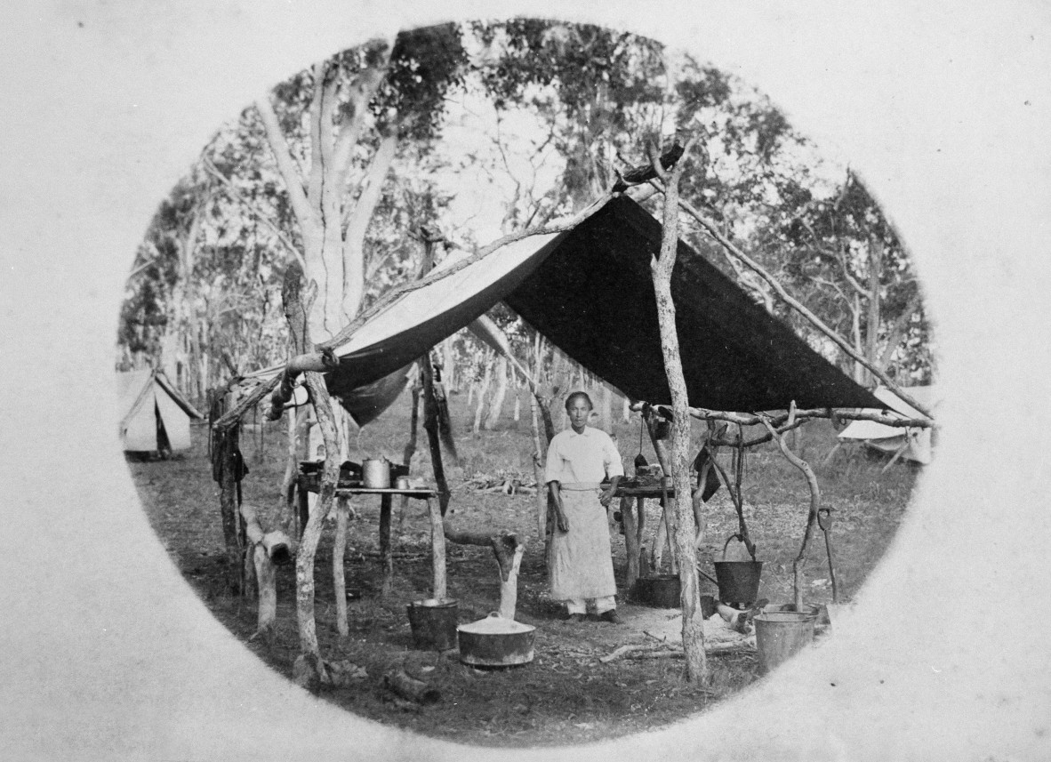Image of a Chinese cook working in the temporary kitchen of a surveyors camp 1886