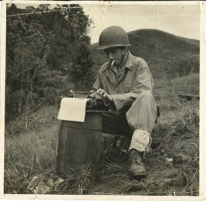 War correspondent Leslie James Fitz-Henry using a typewriter while in the field in Papua New Guinea, around 1945