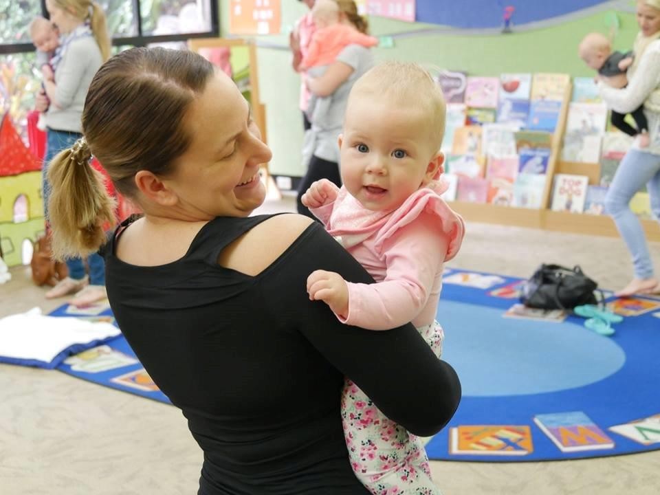 Mother and child playing in a library. 