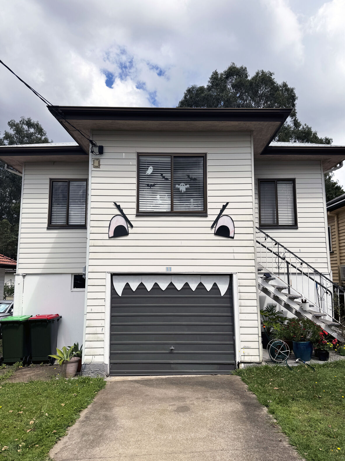 A photo of a house decorated with eyes and teeth for Halloween