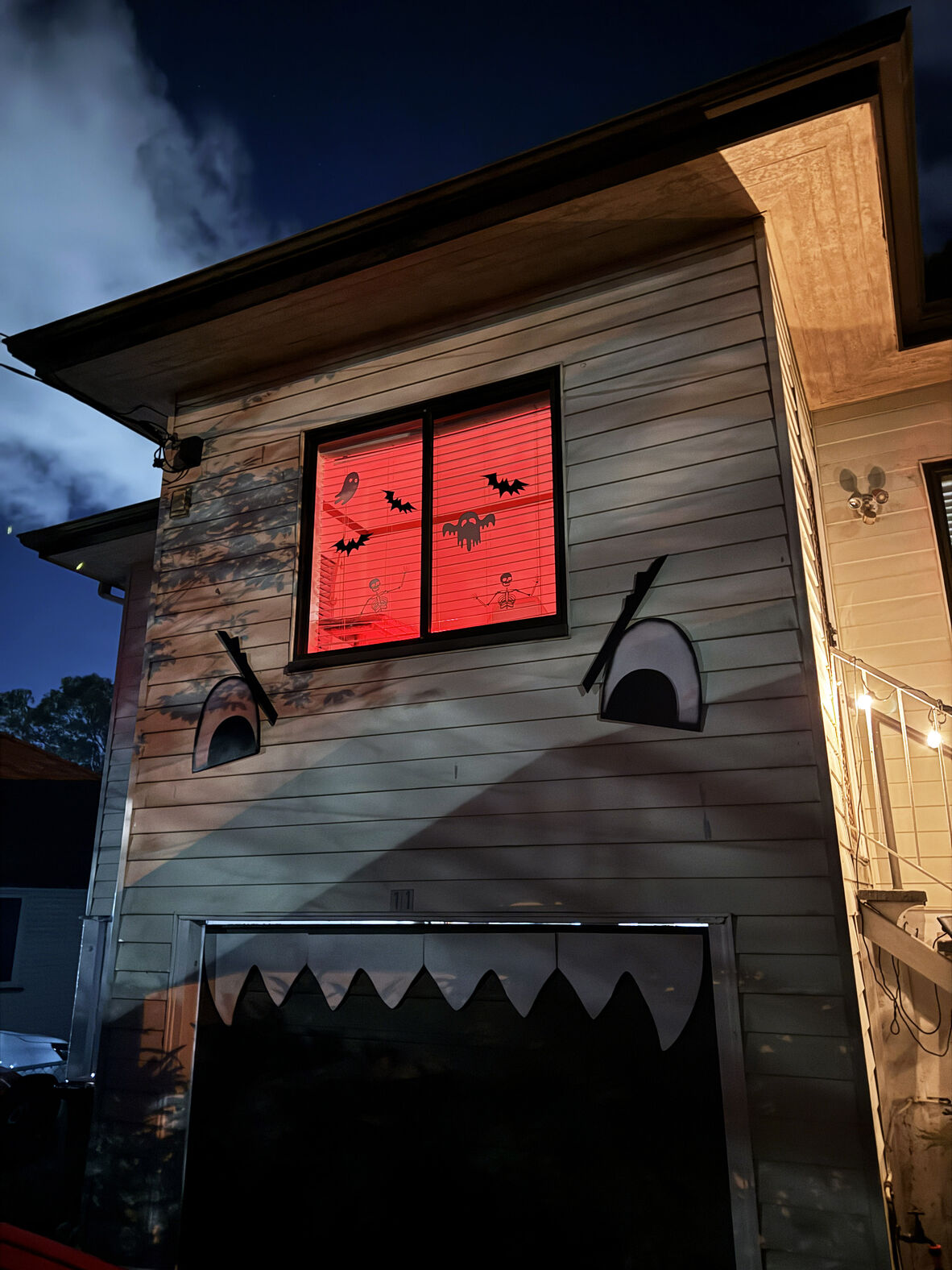 A photo of a house decorated with eyes and teeth for Halloween 