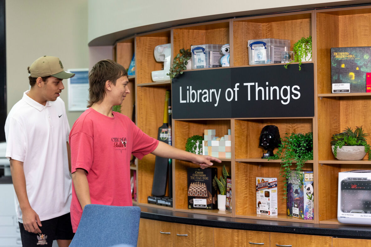 Two people browsing a collection called the Library of Things