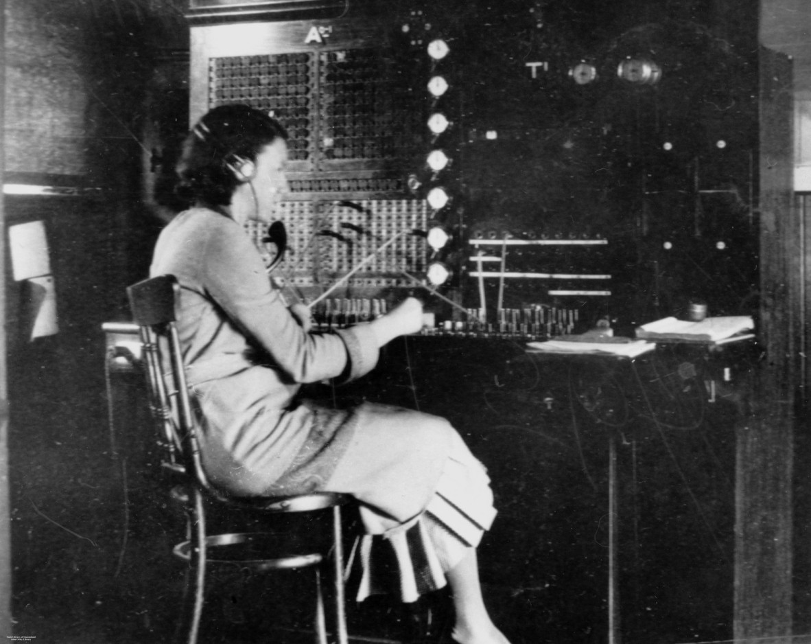 Photo of a female telephonist working at a switchboard