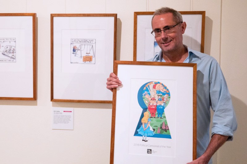 Matt Golding holding his winning artwork