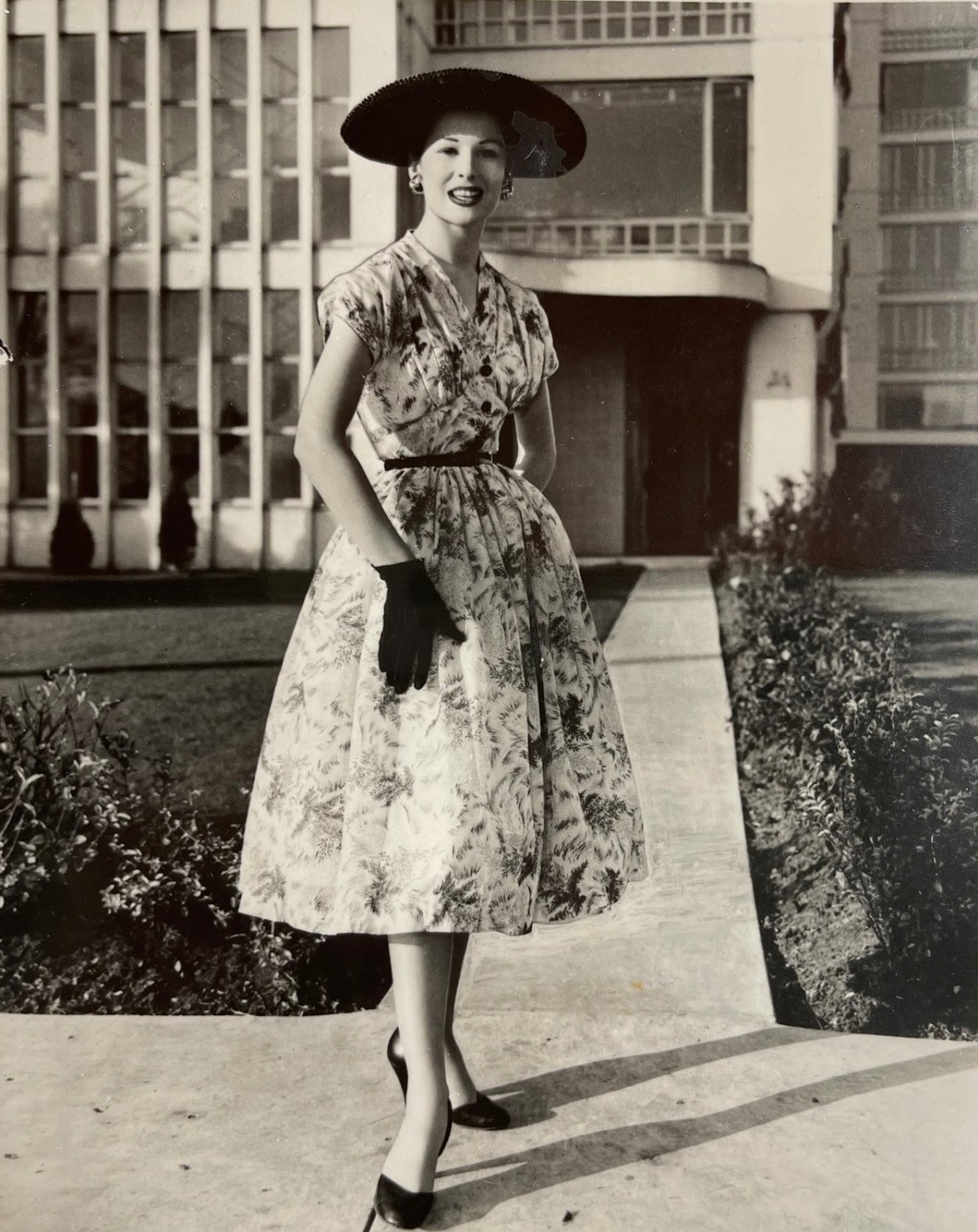 Photograph of a model wearing a dress made from 'Aquarelle' fabric designed by Olive Ashworth, c.1954.