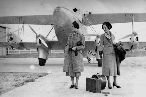 Fashion models in front of a plane taking part in an autumn feature of a McWhirters Clothing supplement