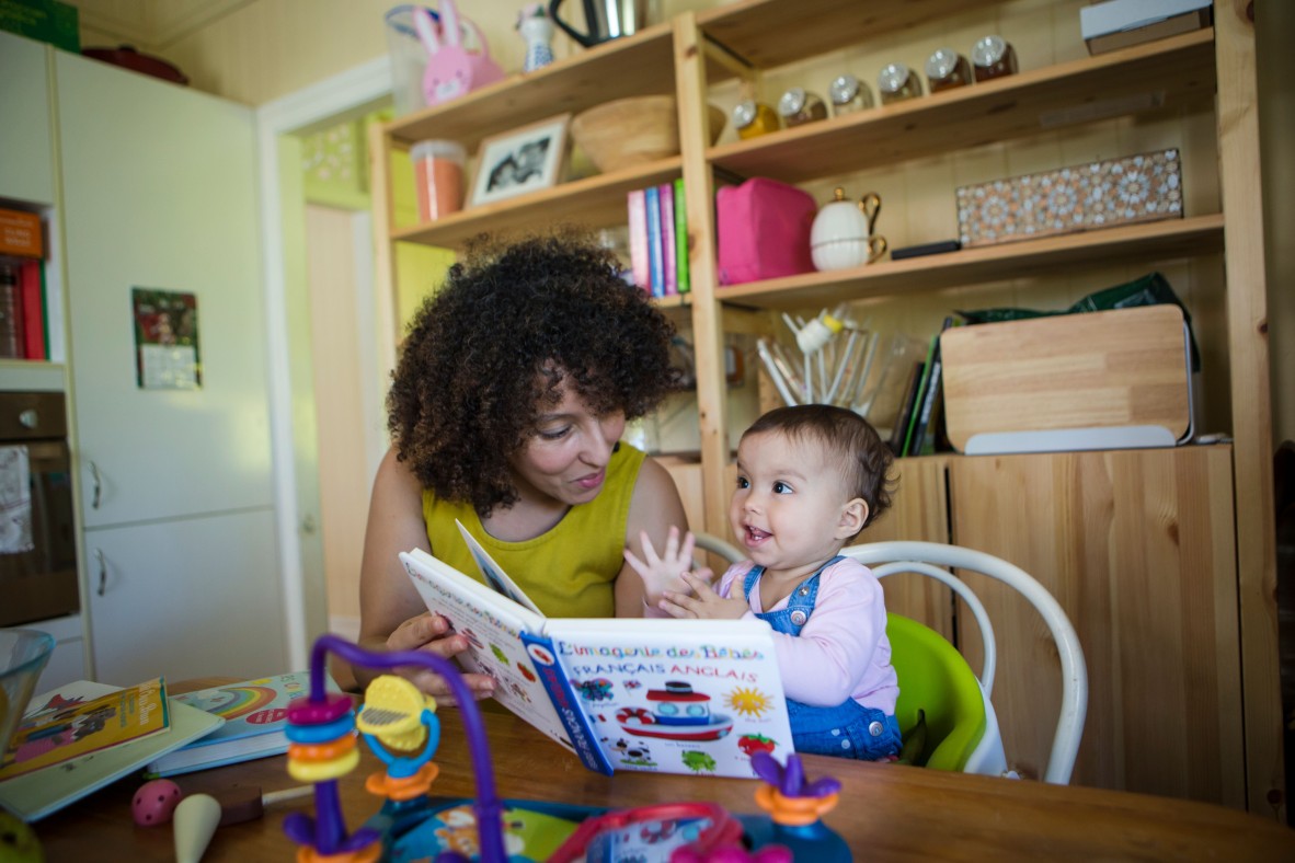 Mother and baby play reading