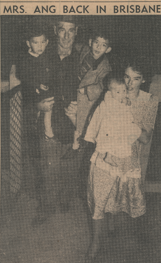 A man, a woman and three children entering a house