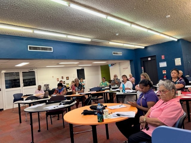 Photo of people at Mt Isa City Library watching presentation