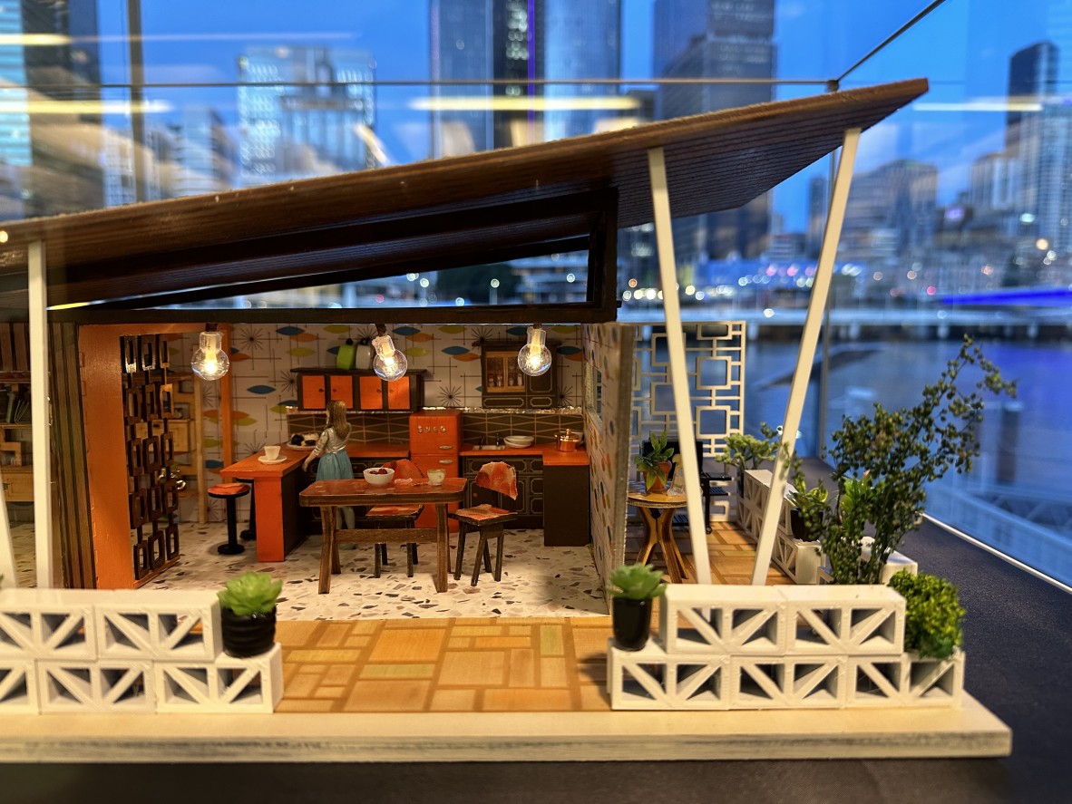 A close up shot of a Mid Century in Miniature Model. The model is showing the layout of kitchen and outdoor patio space.