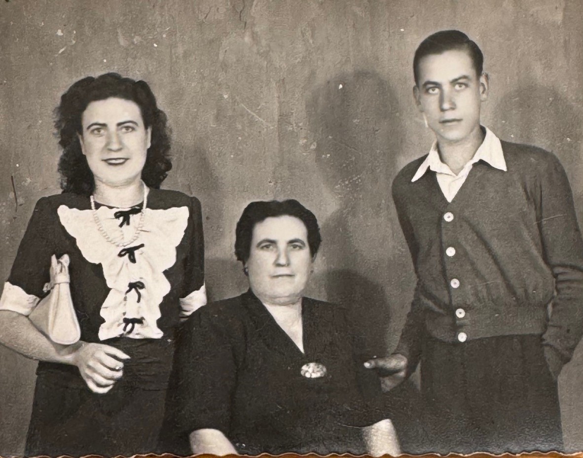 Leonardo's mother, Agata, sitting between Leonardo (standing on right) and his sister, Anna, standing on left.