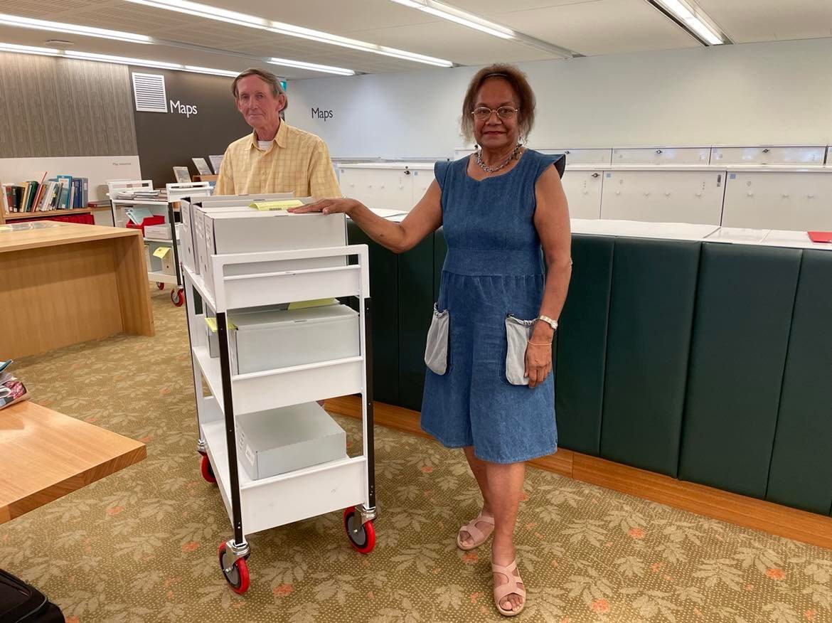 Nasuven Enares and John Harris with the collections in the John Oxley Library Reading Room