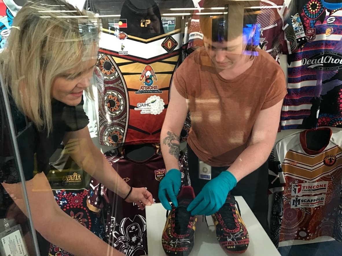 Senior conservator Rachel Spano and Conservation Technician Graduate, Amelia O’Donnell installing Jonathan Thurston’s football boots.