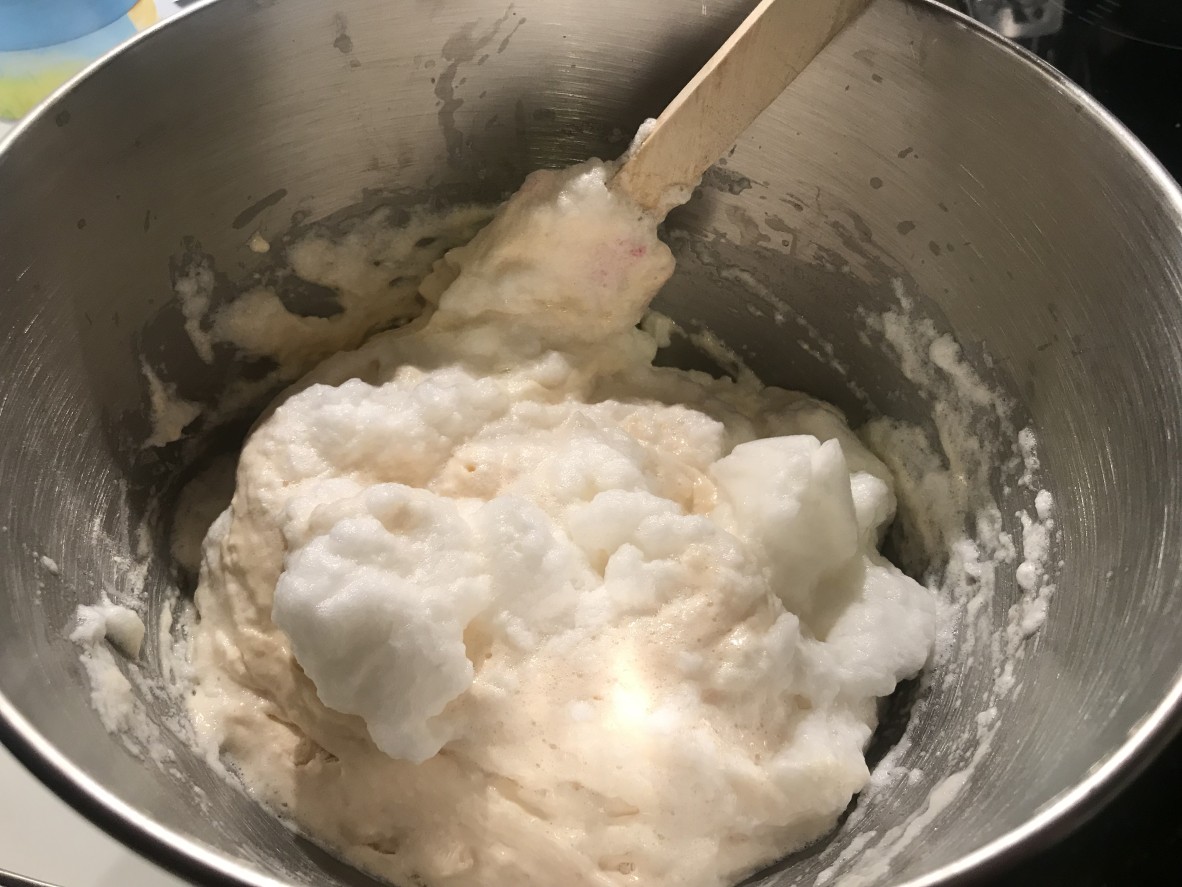 metal bowl containing egg whites an cake batter