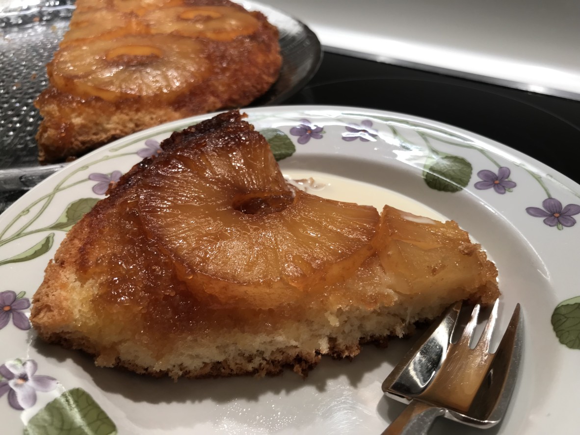 slice of pineapple upside cake on a plate with a fork