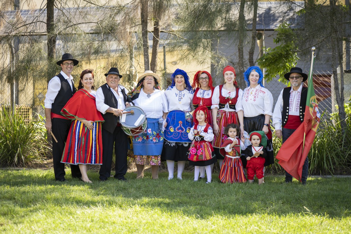 Group of men, womed and children in Portuguese national costume