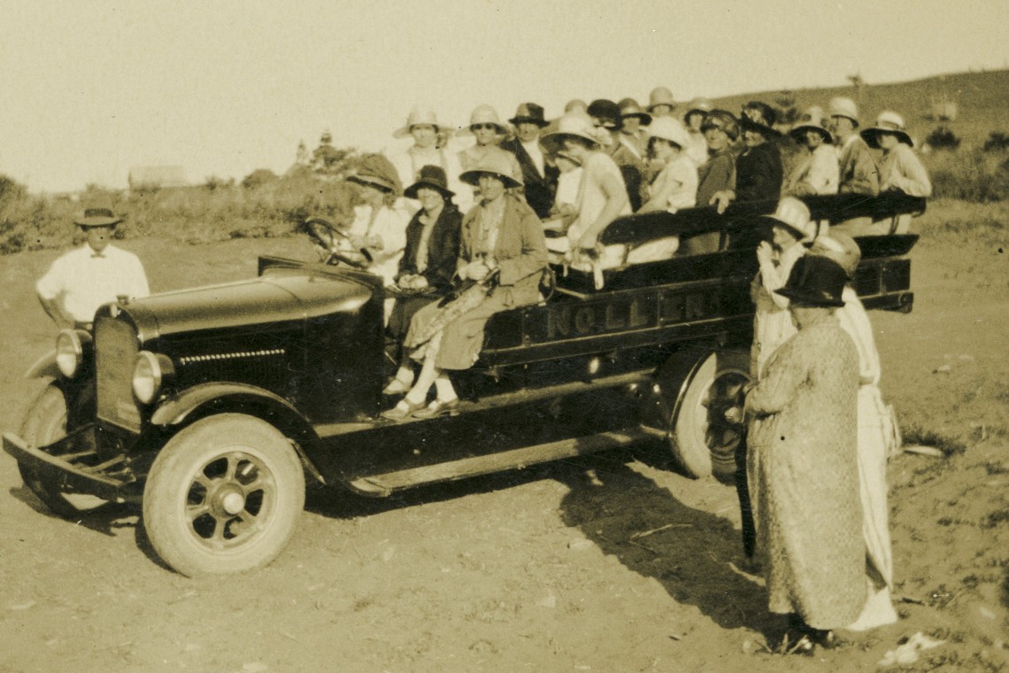 A black of white photogroph of a group of women in a car