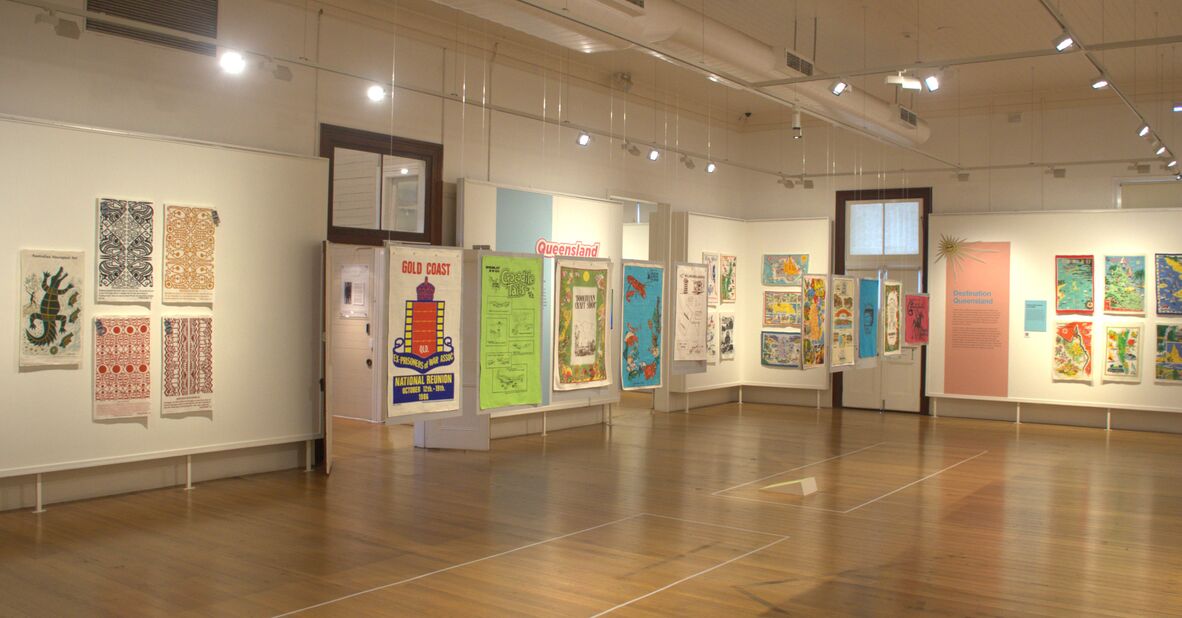 Selection of tea towels on display in a gallery.