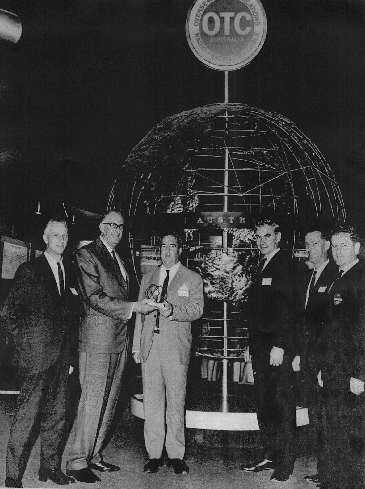 Sir Arthur Petfield and Mr Ray Harris hold an award presented by OTC by the Queensland Chamber of Manufactures for OTCs exhibit at the 1967 Queensland Industries Fair