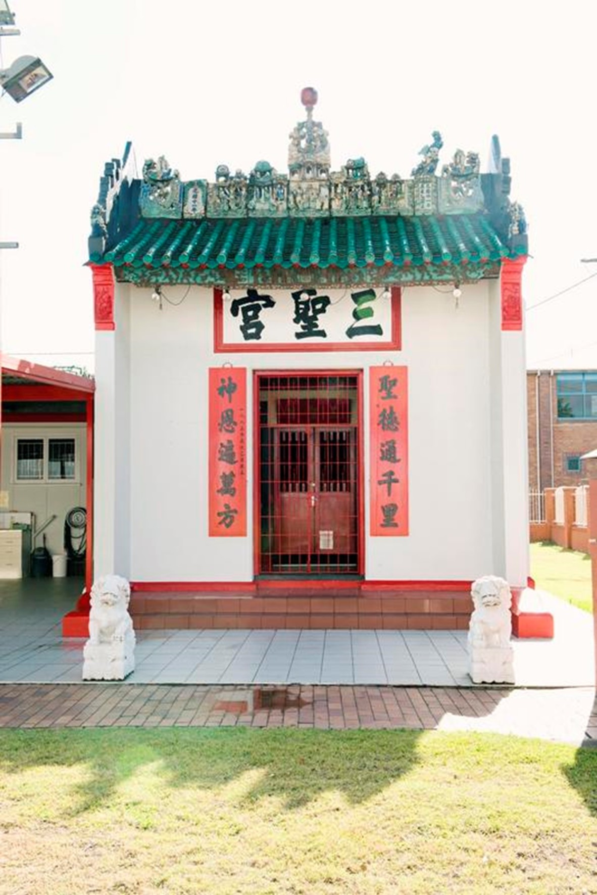 A white temple trimmed in red, green and brown