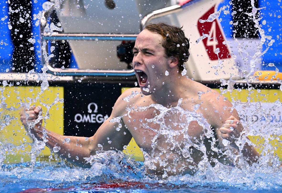 A photo of a swimmer celebrating a win in the water
